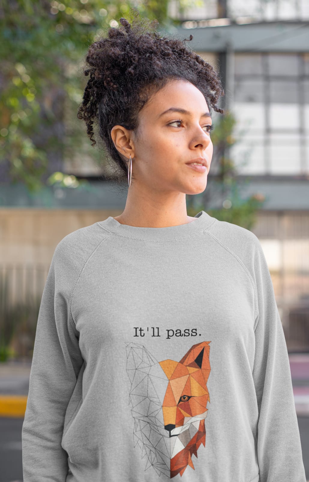 curly haired woman in grey sweatshirt